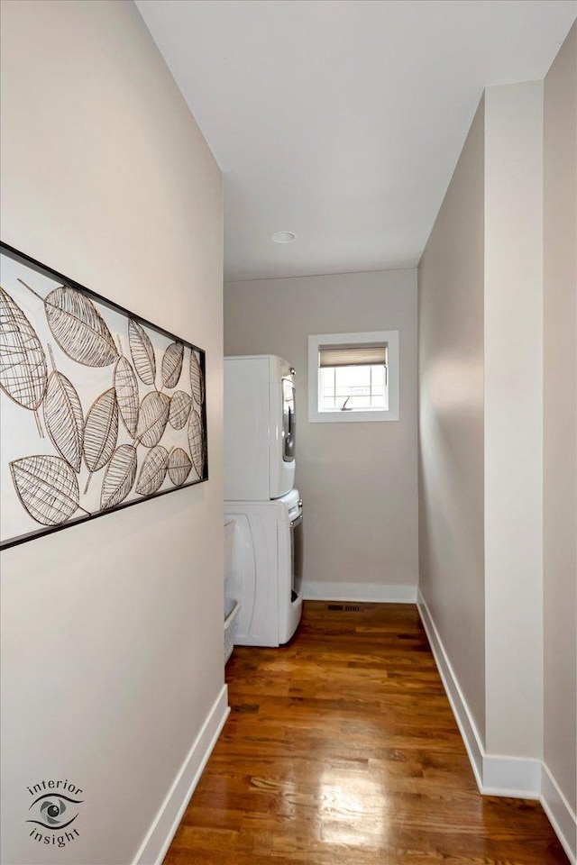 1233 Prairie Ln, Lemont, IL 60439 - hallway with estacked washer and dryer, baseboards, and wood finished floors