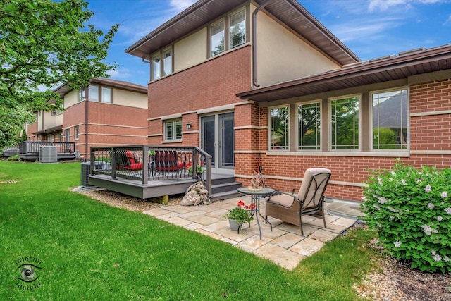 1233 Prairie Ln, Lemont, IL 60439 - back of property with a lawn, a wooden deck, brick siding, a patio area, and stucco siding