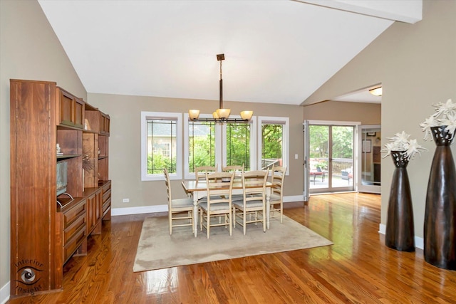 1233 Prairie Ln, Lemont, IL 60439 - dining room featuring lofted ceiling, baseboards, wood finished floors, and a chandelier