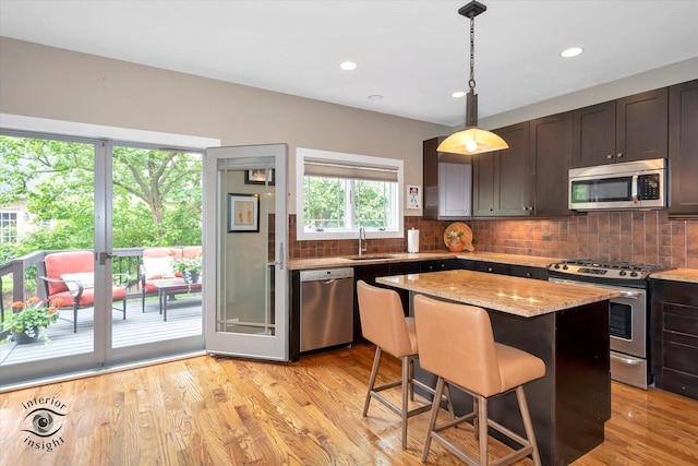 1233 Prairie Ln, Lemont, IL 60439 - kitchen featuring appliances with stainless steel finishes, a sink, backsplash, a center island, and recessed lighting