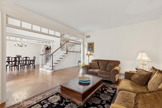 3620 Schillinger Ct, Naperville, IL 60564 - living area with a chandelier, stairway, wood finished floors, and baseboards