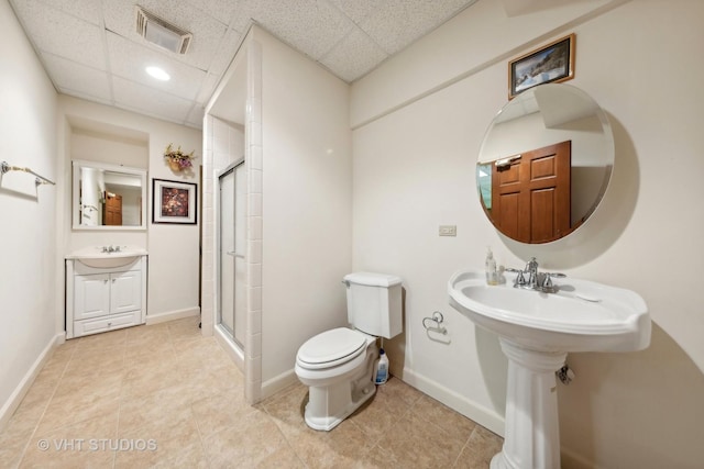 3620 Schillinger Ct, Naperville, IL 60564 - bathroom featuring a paneled ceiling, toilet, a stall shower, a sink, and tile patterned floors
