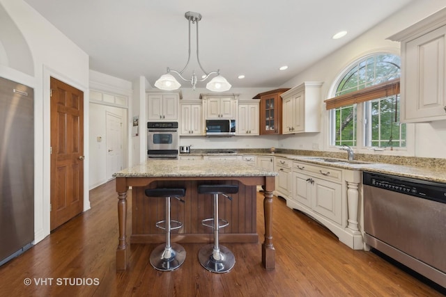 3620 Schillinger Ct, Naperville, IL 60564 - kitchen featuring appliances with stainless steel finishes, a sink, dark wood finished floors, glass insert cabinets, and light stone countertops