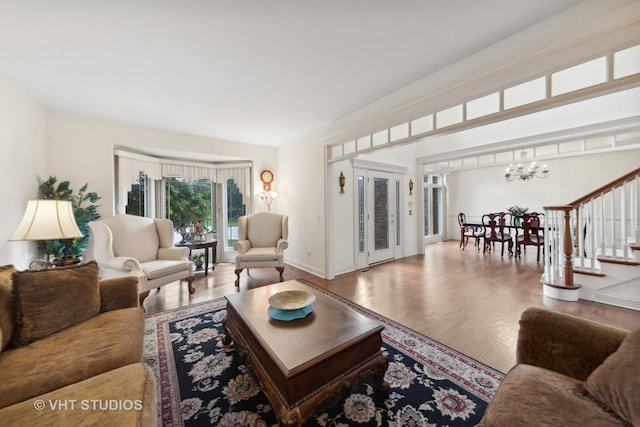 3620 Schillinger Ct, Naperville, IL 60564 - living room featuring a chandelier, stairs, wood finished floors, and baseboards