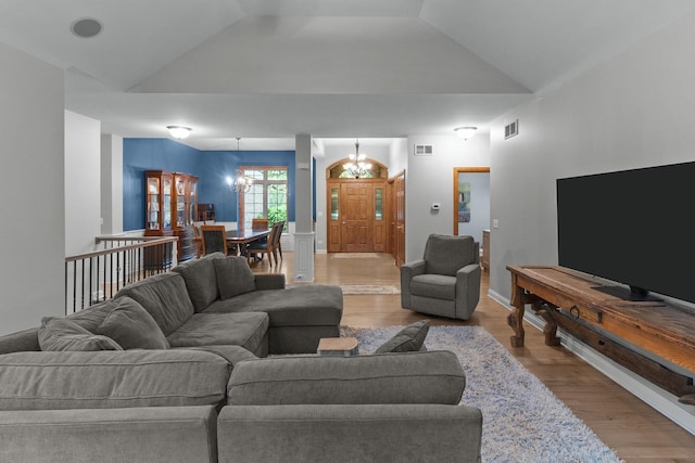 10920 Preservation Way, Richmond, IL 60071 - living room featuring a chandelier, wood finished floors, and vaulted ceiling