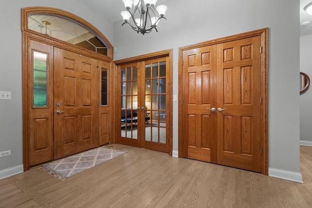 10920 Preservation Way, Richmond, IL 60071 - entryway featuring french doors, wood finished floors, baseboards, and a chandelier