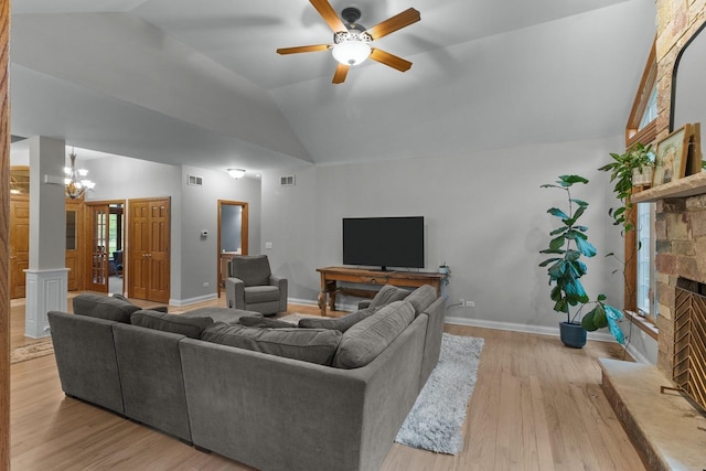 10920 Preservation Way, Richmond, IL 60071 - living room featuring lofted ceiling, a fireplace, ceiling fan, wood finished floors, and a chandelier