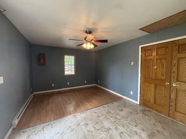 85 Circle Dr E, Montgomery, IL 60538 - unfurnished bedroom featuring a baseboard radiator, baseboards, wood finished floors, and ceiling fan
