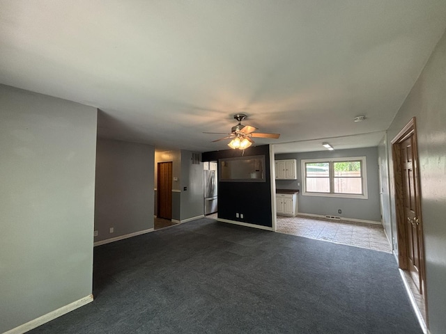 85 Circle Dr E, Montgomery, IL 60538 - unfurnished living room featuring carpet flooring, a ceiling fan, and baseboards