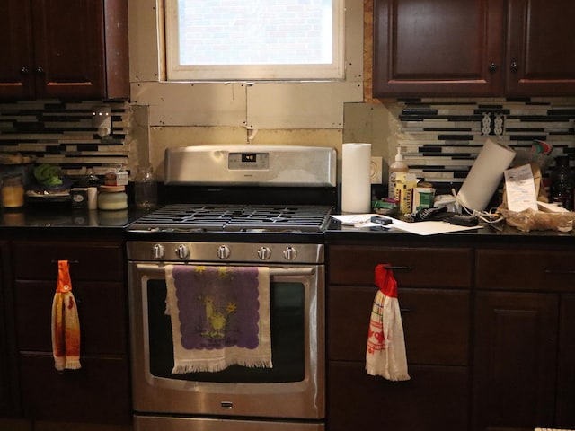 312 S Monroe St, Streator, IL 61364 - kitchen with stainless steel gas stove, tasteful backsplash, dark countertops, and dark brown cabinets