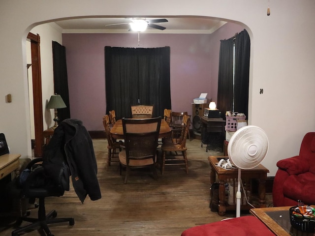 312 S Monroe St, Streator, IL 61364 - dining space featuring arched walkways, crown molding, wood finished floors, and ceiling fan