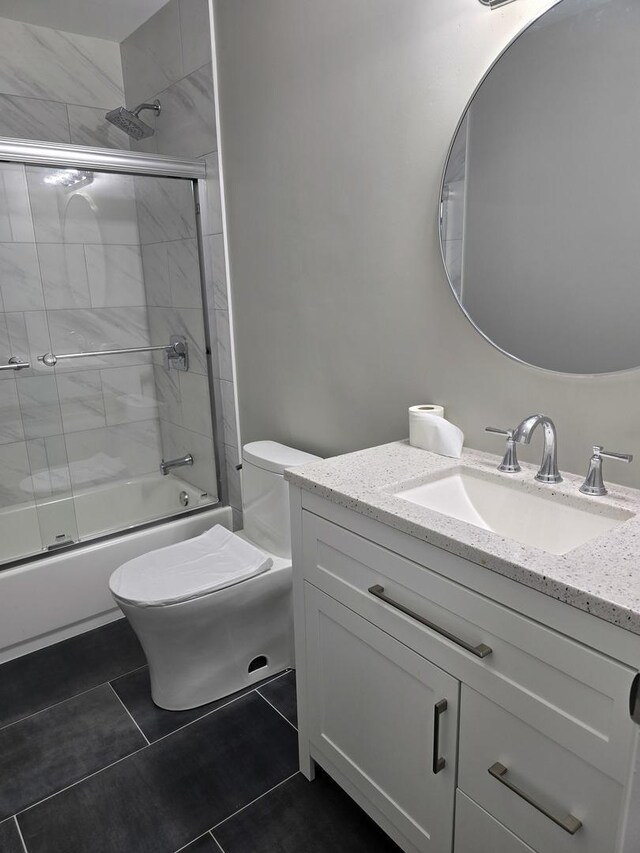 177 E Fullerton Ave, Glendale Heights, IL 60139 - bathroom featuring vanity, enclosed tub / shower combo, toilet, and tile patterned floors
