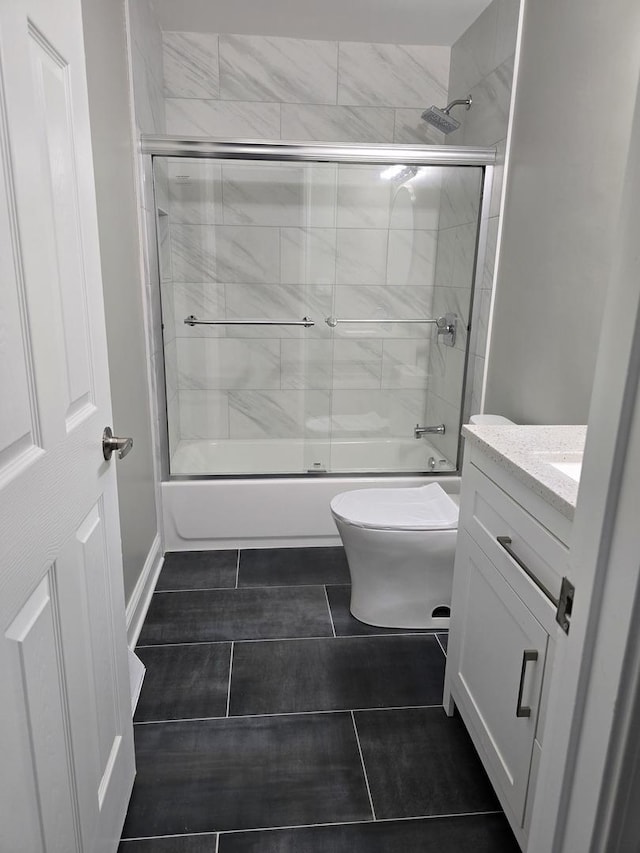 177 E Fullerton Ave, Glendale Heights, IL 60139 - bathroom featuring vanity, enclosed tub / shower combo, toilet, and tile patterned floors