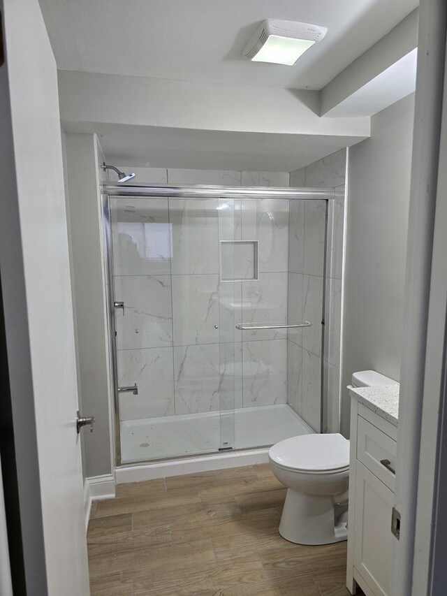 177 E Fullerton Ave, Glendale Heights, IL 60139 - full bath featuring toilet, vanity, a shower stall, and wood finished floors