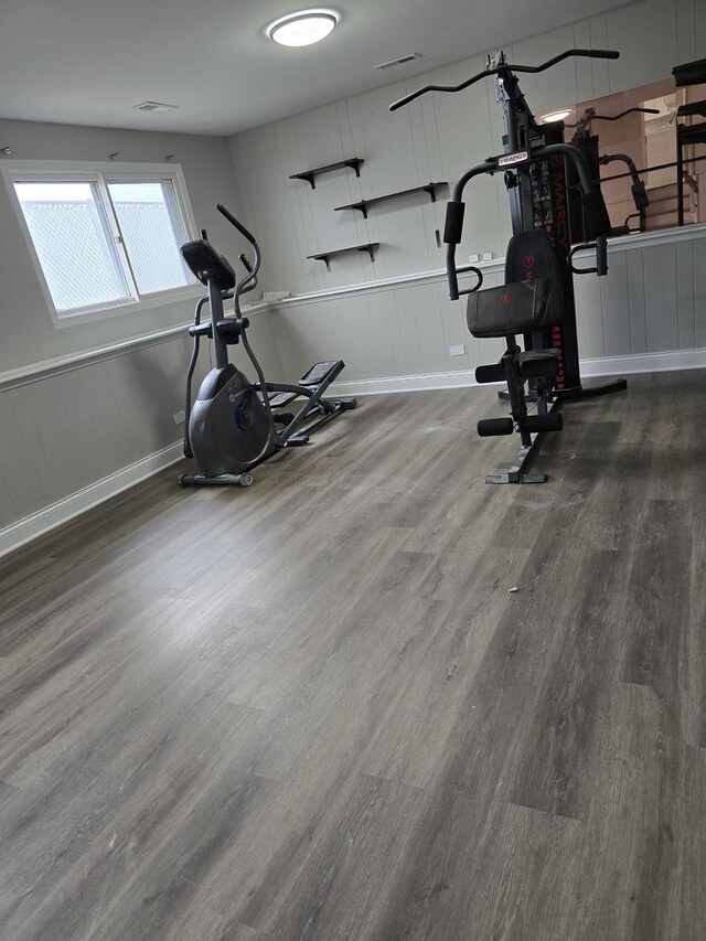 177 E Fullerton Ave, Glendale Heights, IL 60139 - workout area featuring wood finished floors, a decorative wall, and baseboards