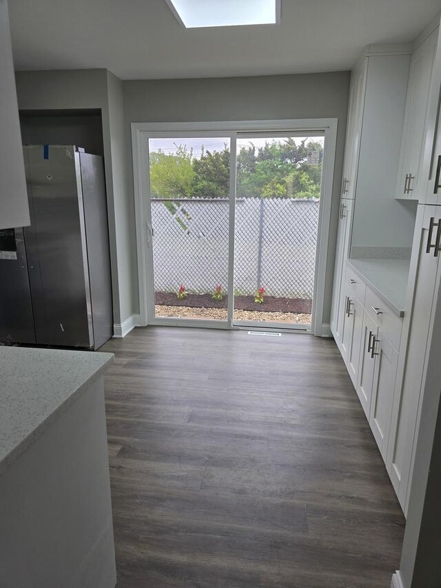 177 E Fullerton Ave, Glendale Heights, IL 60139 - unfurnished dining area featuring plenty of natural light, dark wood-style flooring, and baseboards