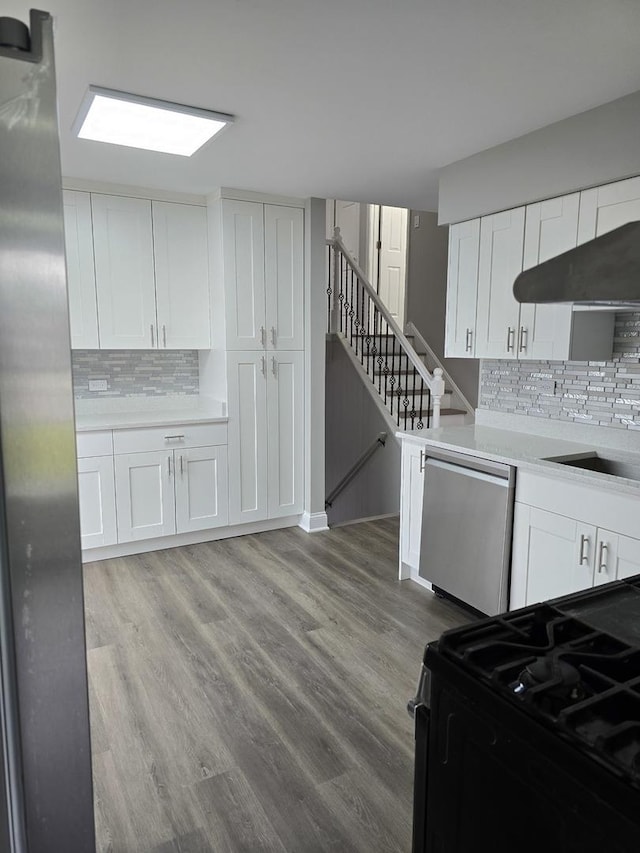 177 E Fullerton Ave, Glendale Heights, IL 60139 - kitchen with black range with gas stovetop, dishwasher, decorative backsplash, and white cabinets