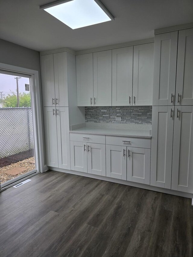 177 E Fullerton Ave, Glendale Heights, IL 60139 - kitchen featuring dark wood-type flooring, light countertops, decorative backsplash, and white cabinetry
