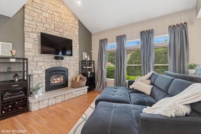 31730 N Clearwater Dr, Lakemoor, IL 60051 - living room with wood finished floors, a stone fireplace, and high vaulted ceiling