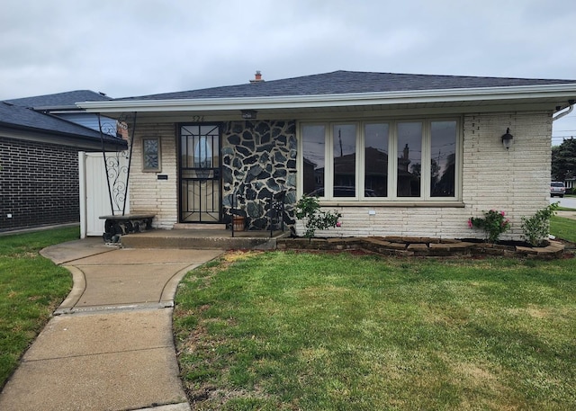 526 Marquette Ave, Calumet City, IL 60409 - view of front facade featuring a front yard, brick siding, a shingled roof, and stone siding