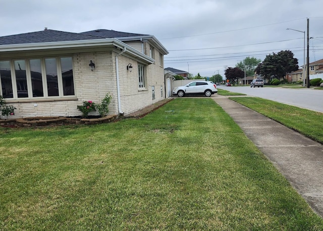 526 Marquette Ave, Calumet City, IL 60409 - view of side of home with brick siding, a lawn, and a shingled roof