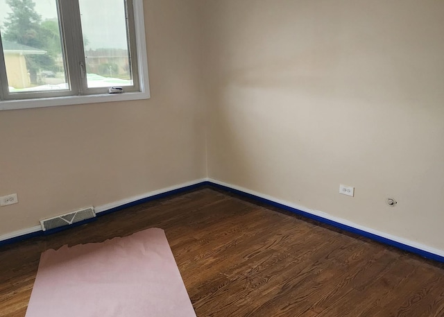 526 Marquette Ave, Calumet City, IL 60409 - unfurnished room featuring baseboards and dark wood-type flooring