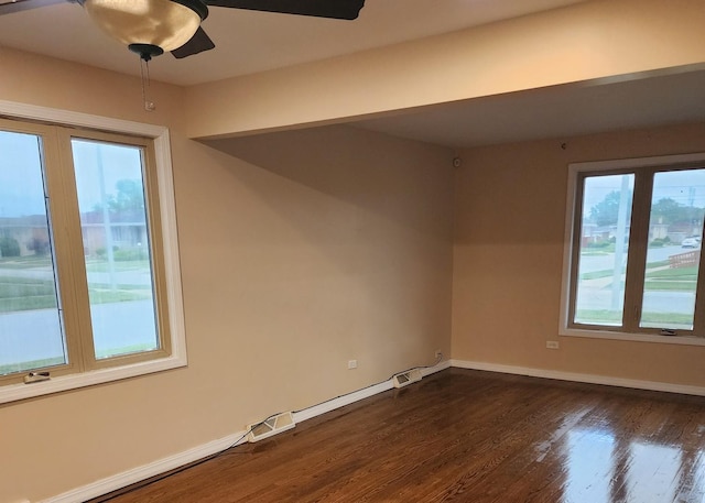 526 Marquette Ave, Calumet City, IL 60409 - spare room featuring plenty of natural light, dark wood-style flooring, baseboards, and ceiling fan