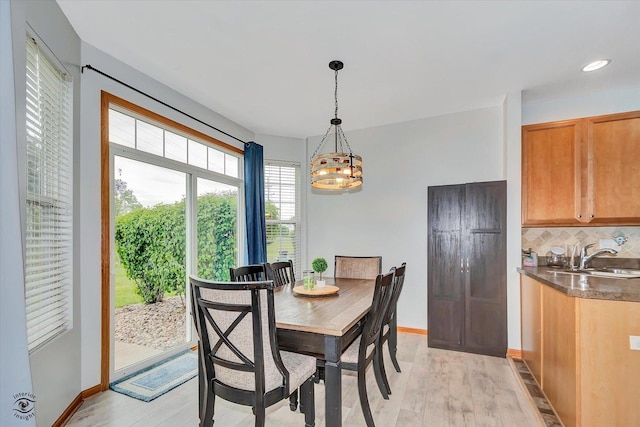 15255 Kenmare Cir, Manhattan, IL 60442 - dining space with light wood finished floors, a chandelier, wet bar, and recessed lighting
