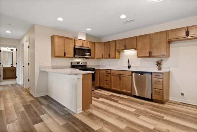 2034 W 75th Pl Unit 36, Merrillville, IN 46410 - kitchen featuring stainless steel appliances, light wood finished floors, light countertops, and recessed lighting
