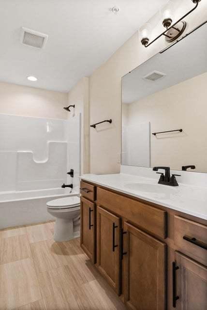 2034 W 75th Pl Unit 36, Merrillville, IN 46410 - bathroom featuring toilet, shower / tub combination, and vanity