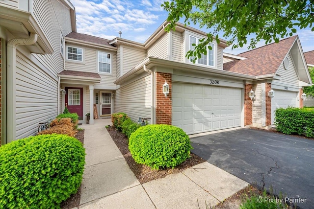 3208 Raphael Ct, Saint Charles, IL 60175 - view of front facade with brick siding, asphalt driveway, a shingled roof, and an attached garage