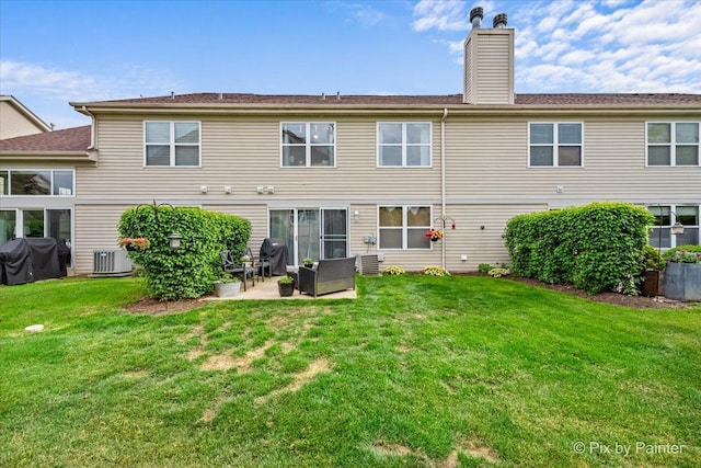 3208 Raphael Ct, Saint Charles, IL 60175 - back of property featuring a chimney, a lawn, a patio area, and central AC unit