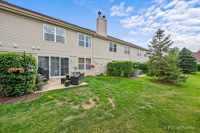 3208 Raphael Ct, Saint Charles, IL 60175 - rear view of house with a chimney, a patio area, and a lawn