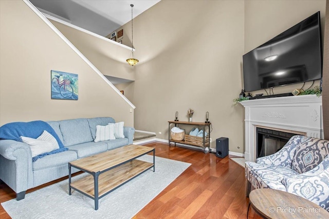 3208 Raphael Ct, Saint Charles, IL 60175 - living room featuring wood finished floors, a fireplace with flush hearth, baseboards, and stairway