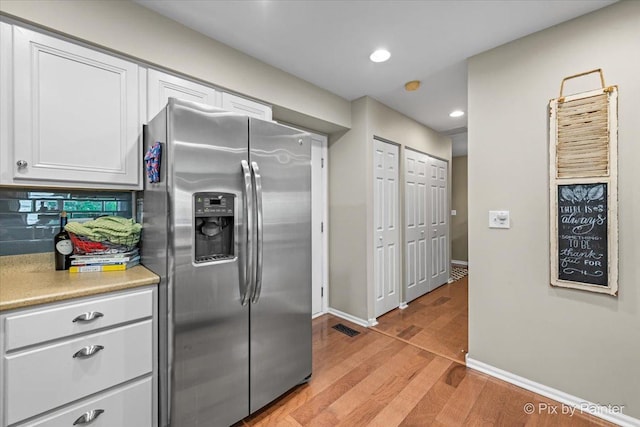 3208 Raphael Ct, Saint Charles, IL 60175 - kitchen with stainless steel fridge with ice dispenser, light wood-style floors, white cabinetry, light countertops, and baseboards