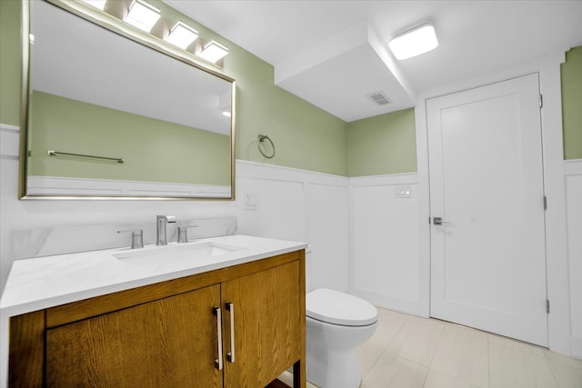 6014 W Fletcher St, Chicago, IL 60634 - bathroom featuring vanity, toilet, tile patterned flooring, and wainscoting