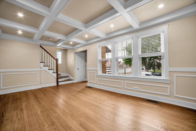 6014 W Fletcher St, Chicago, IL 60634 - unfurnished living room featuring coffered ceiling, a decorative wall, stairs, wainscoting, and beamed ceiling