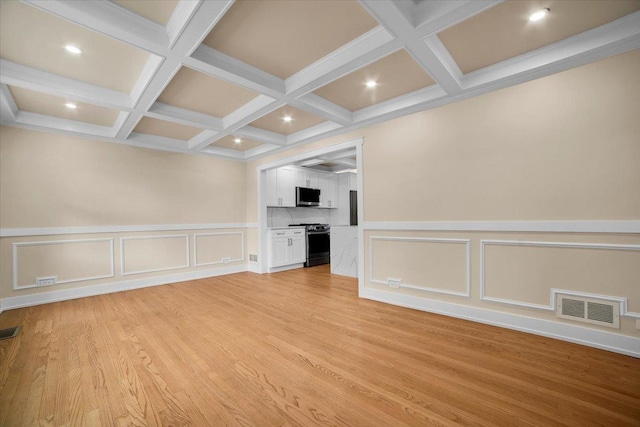 6014 W Fletcher St, Chicago, IL 60634 - unfurnished living room featuring coffered ceiling, a decorative wall, beam ceiling, light wood-type flooring, and recessed lighting