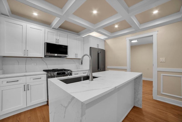 6014 W Fletcher St, Chicago, IL 60634 - kitchen with stainless steel appliances, a sink, coffered ceiling, decorative backsplash, and white cabinets