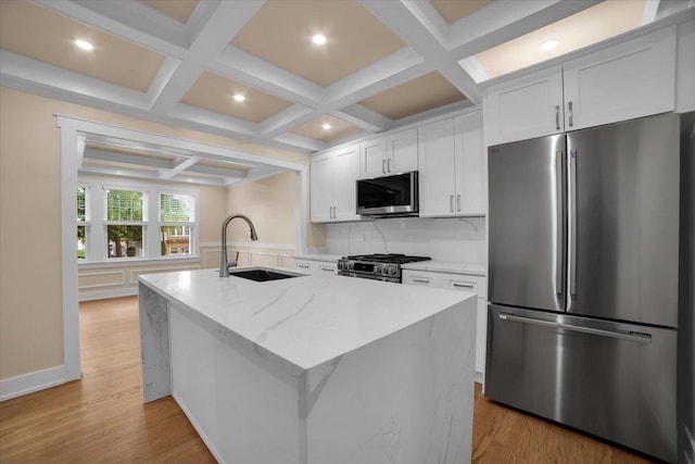 6014 W Fletcher St, Chicago, IL 60634 - kitchen featuring appliances with stainless steel finishes, a sink, coffered ceiling, white cabinetry, and an island with sink