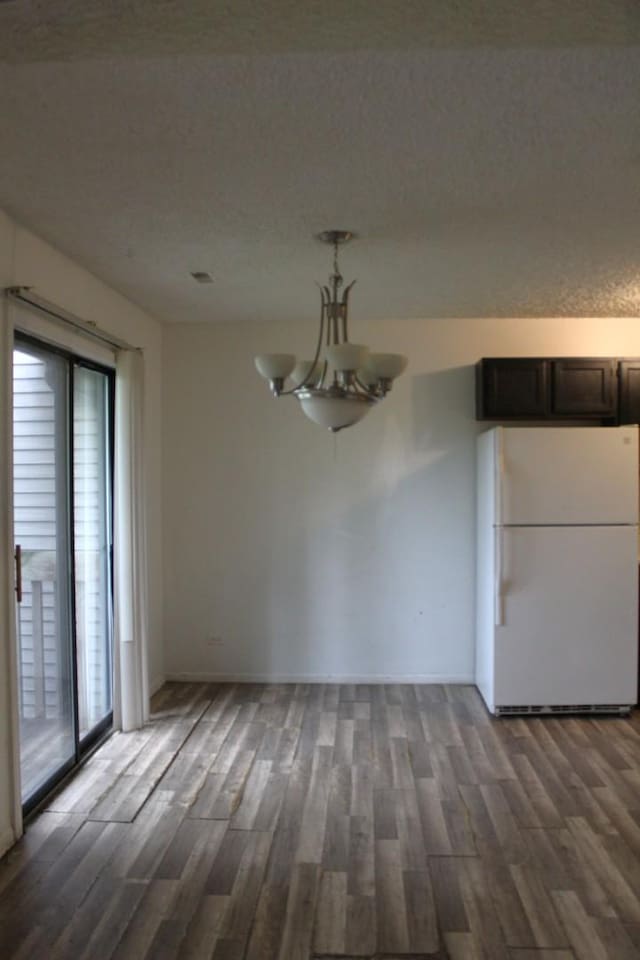 2364 S St Unit C, Elgin, IL 60123 - unfurnished dining area with wood finished floors, a chandelier, plenty of natural light, and baseboards
