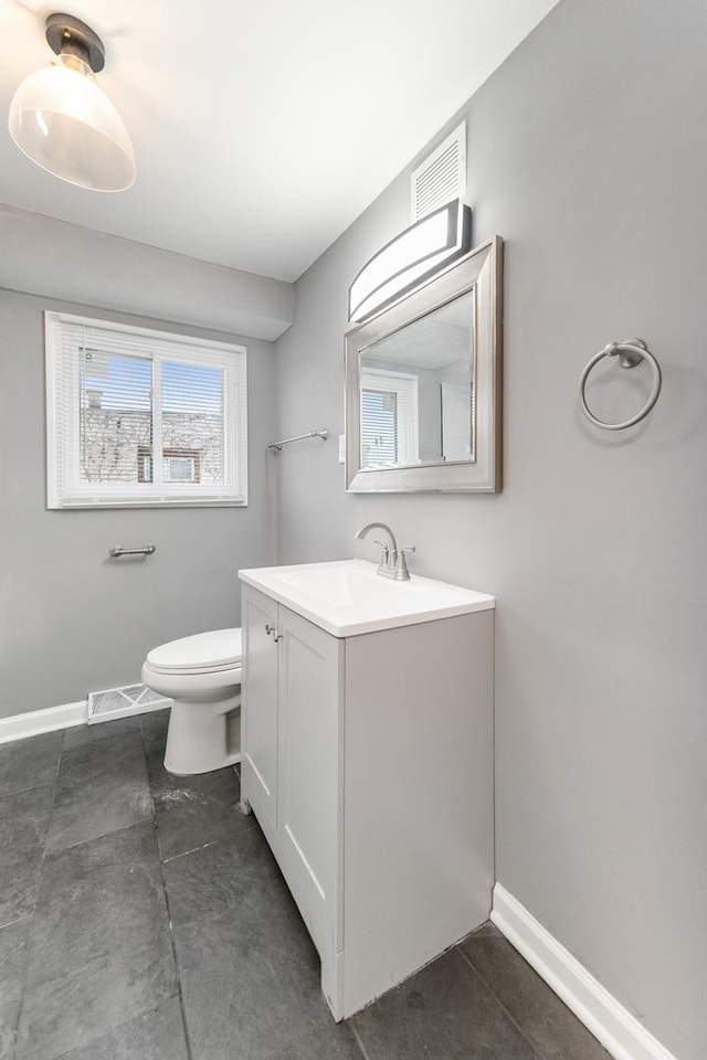 11423 S Calumet Ave, Chicago, IL 60628 - bathroom with baseboards, vanity, and toilet