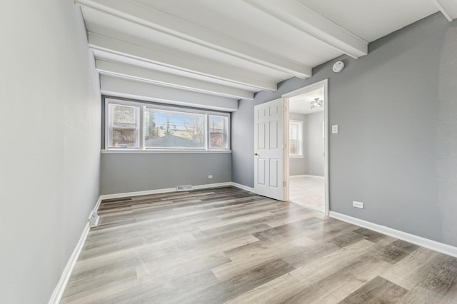 11423 S Calumet Ave, Chicago, IL 60628 - unfurnished bedroom featuring beam ceiling, wood finished floors, and baseboards