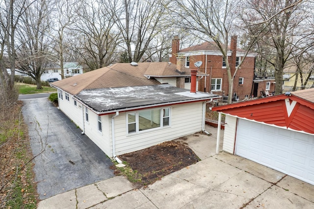 17401 Holmes Ave, Hazel Crest, IL 60429 - view of front of home featuring a shingled roof, a chimney, driveway, a detached garage, and a residential view