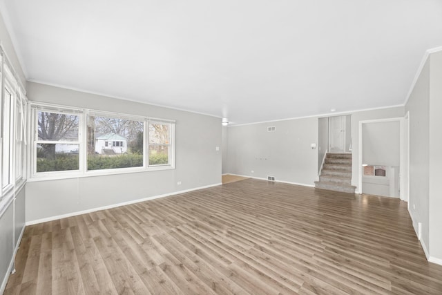 17401 Holmes Ave, Hazel Crest, IL 60429 - unfurnished living room with ornamental molding, light wood-type flooring, and baseboards