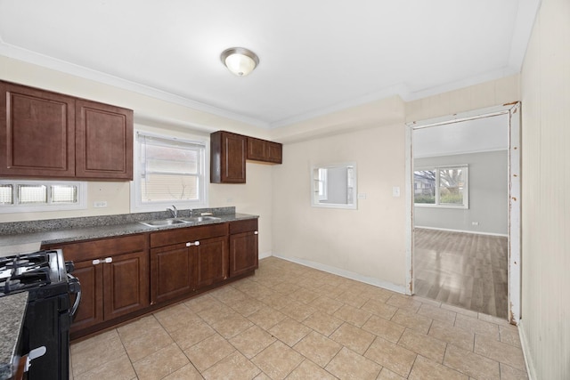 17401 Holmes Ave, Hazel Crest, IL 60429 - kitchen featuring black gas range, a sink, dark countertops, crown molding, and baseboards