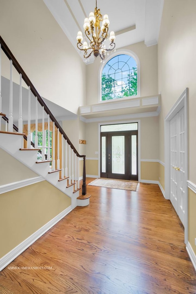 792 Black Walnut Dr, Sugar Grove, IL 60554 - foyer featuring a high ceiling, a chandelier, wood finished floors, and stairway