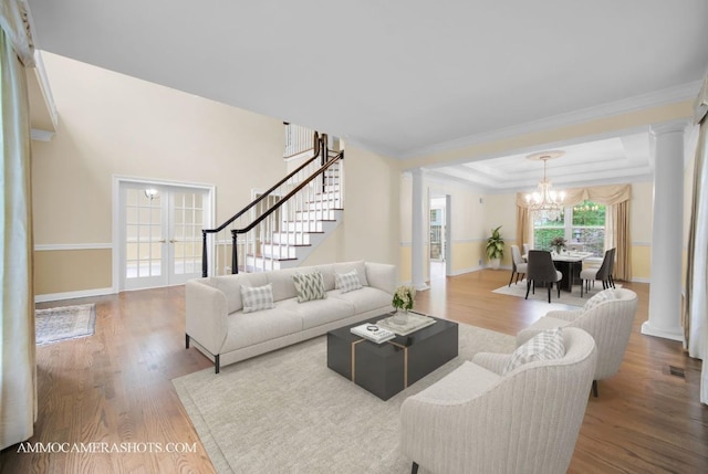 792 Black Walnut Dr, Sugar Grove, IL 60554 - living room featuring a chandelier, decorative columns, wood finished floors, stairs, and ornamental molding
