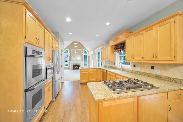 792 Black Walnut Dr, Sugar Grove, IL 60554 - kitchen with stainless steel appliances, a peninsula, light brown cabinets, light wood-style floors, and lofted ceiling