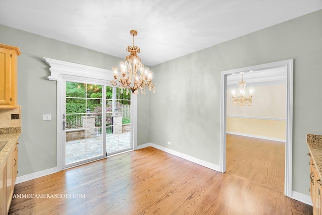 792 Black Walnut Dr, Sugar Grove, IL 60554 - unfurnished dining area with a chandelier and light wood finished floors